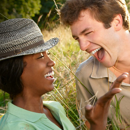 Couple laughing about a black humor joke